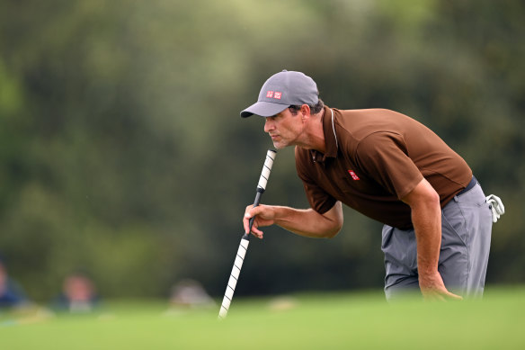 Adam Scott lines up a putt during the opening round.