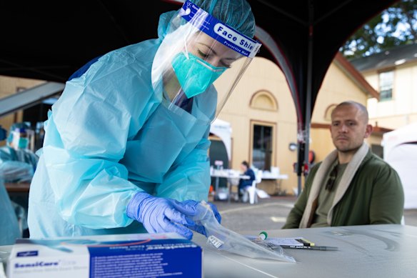 Andrew Hite has a COVID-19 test at a popup clinic run by St Vincent's Hospital in Rushcutters Bay. The Potts Point cluster expanded to 24 cases on Saturday.