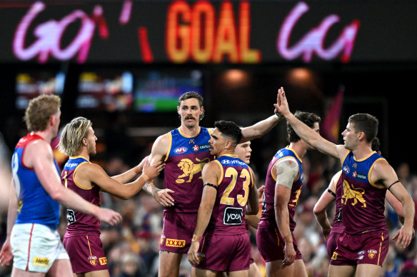 Joe Daniher of the Lions celebrates with teammates.