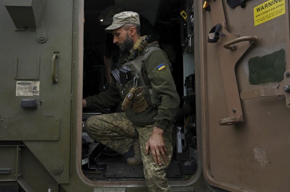 Vitaly waits for fresh troops to shuttle to the frontline in the Bendigo-made armoured carrier. 