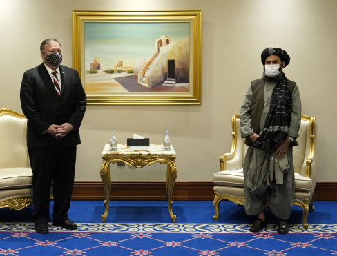 Then-Secretary of State Mike Pompeo meets with Mullah Abdul Ghani Baradar, head of the Taliban’s peace negotiation team, amid talks between the Taliban and the Afghan government in Doha, Qatar in 2020.