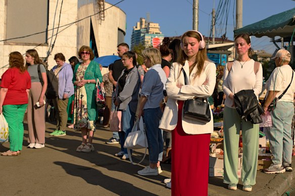 Kyivites pause to observe Ukraine’s daily national minute’s silence in memory of those killed in the war.