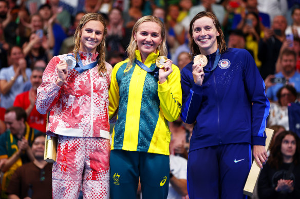 Gold medallist Ariarne Titmus, centre, stands with silver medallist Summer McIntosh and bronze medallist Katie Ledecky.