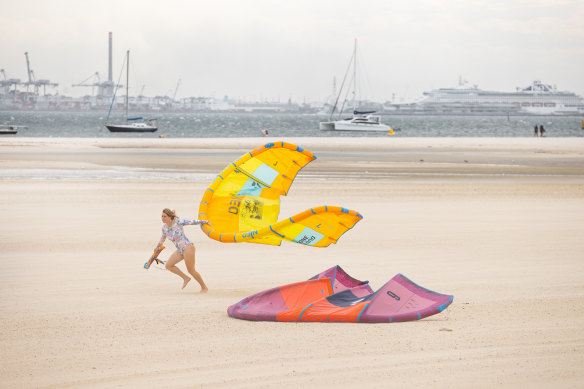A kite surfer struggles with the wind as the heat gives way to a cool change at St Kilda beach on Friday afternoon.