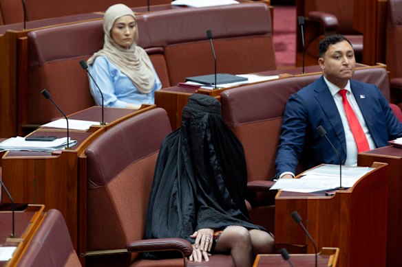 Senator Fatima Payman watches Pauline Hanson’s burqa stunt in the chamber last year.