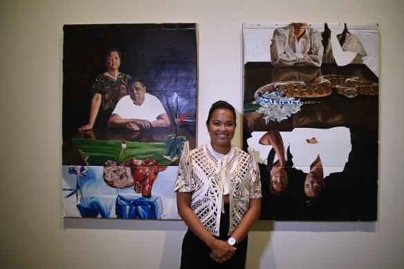 Marikit Santiago with her winning paintings ‘A Seat at the Table (Magulang)’ and ‘A Seat at the Table (Kapatid)’.