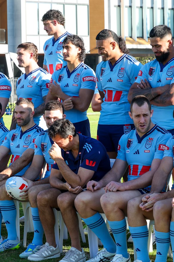 Haumole Olakau’atu sits behind Laurie Daley at Tuesday’s team photo after being told he was now 20th man.