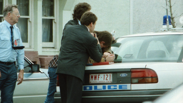 Police colleagues try to console Michael Lamb after a bullet from his gun shot fellow officer Ben Piper.