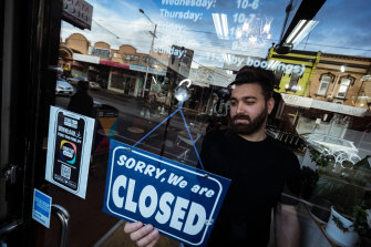 Mas Azemi of Mas Barber Shop in Brunswick closes his shop in August. Many Melbourne businesses remain shut under lockdown restrictions.