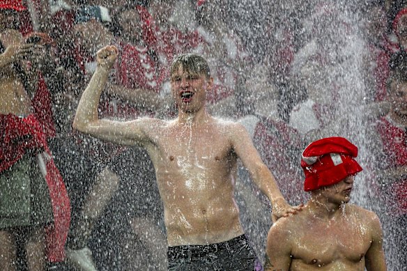 ans dance in the rain while a round of sixteen match between Germany and Denmark at the Euro 2024 soccer tournament is suspended in Dortmund, Germany, Saturday, June 29, 2024. 