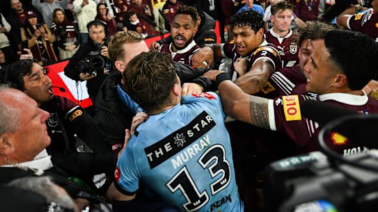 Cameron Murray runs into a sea of Maroons players to fight from the bench.