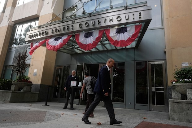 People walk outside of a Federal Courthouse Wednesday, Aug. 12, 2026, in Oakland, California