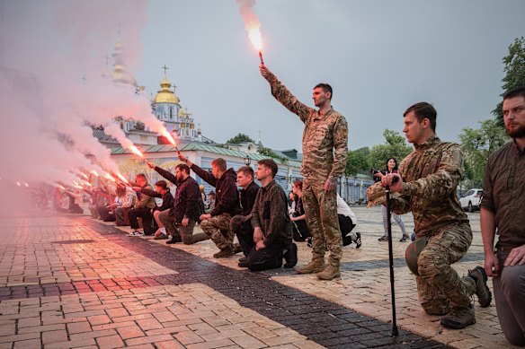 People light up flares during the funeral ceremony of fallen Ukrainian serviceman of 3rd assault brigade Yaroslav Ivanov in Kyiv, Ukraine.