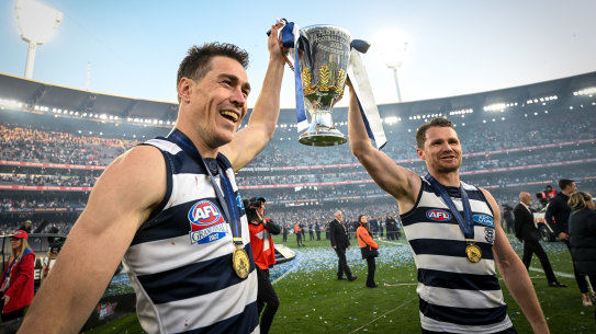 Jeremy Cameron and Patrick Dangerfield celebrate Geelong’s premiership last year. The annual captains’ survey predicts the Cats will again make the grand final this year.