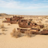 Moynaq, once a fishing port on the Aral Sea, is now a ghost town in the Aralkum Desert, drawing ‘disaster tourists’ to see stranded boats and devastation.