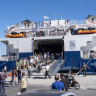 A ferry disgorging its passengers.
