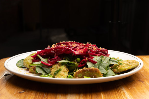 Leniwe (Polish-style gnocchi) with spinach and peas and showered with shredded pickled beetroot. 