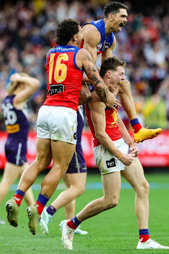 Brisbane players celebrate a goal by Logan Morris goal in th dying minutes to seal the game for Brisbane in the 2026 AFL grand final.