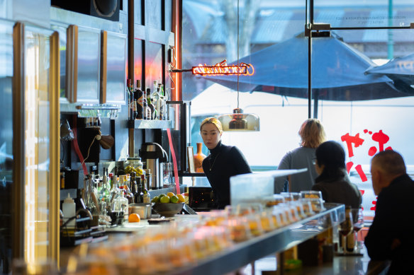 The sushi train sits atop a solid-brass, curved-edge table.