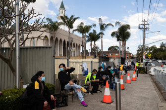 People line up near Lakemba Mosque in south-western Sydney to receive their vaccinations at a pop-up clinic.