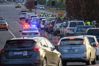 Quesues of commuters bank up at the NSW border as police stop drivers from Victoria to check their permits and licenses.