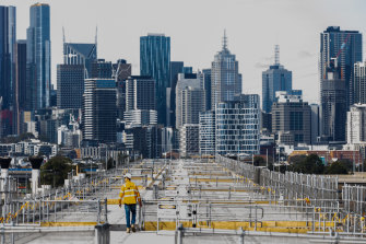 A worker on top of the elevated road that will tower over Footscray Road, connecting the west to the CBD.