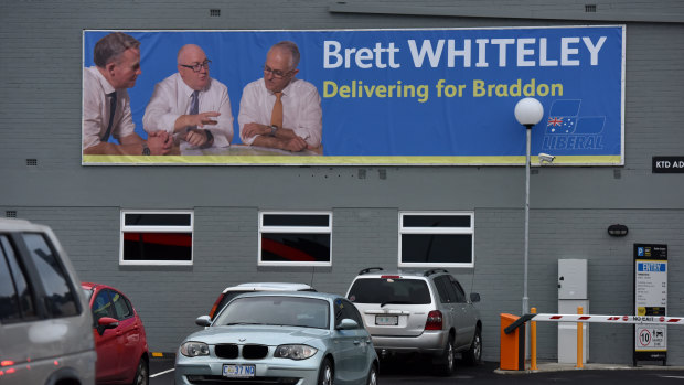 A billboard for Liberal candidate Brett Whiteley in Burnie, Tasmania, sees him flanked by the state's premier Will Hodgman and Prime Minister Malcolm Turnbull.