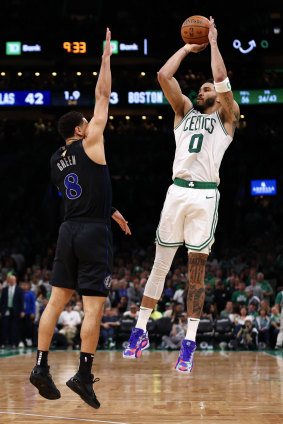 Jayson Tatum #0 of the Boston Celtics shoots the ball against Josh Green #8 of the Dallas Mavericks.
