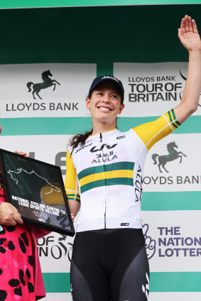 Ruby Roseman-Gannon celebrates on the podium in Manchester as a stage winner.