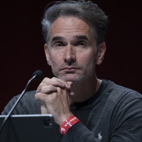 Ad guru Todd Sampson scraped through with his re-election to the Qantas board despite a strong protest vote.