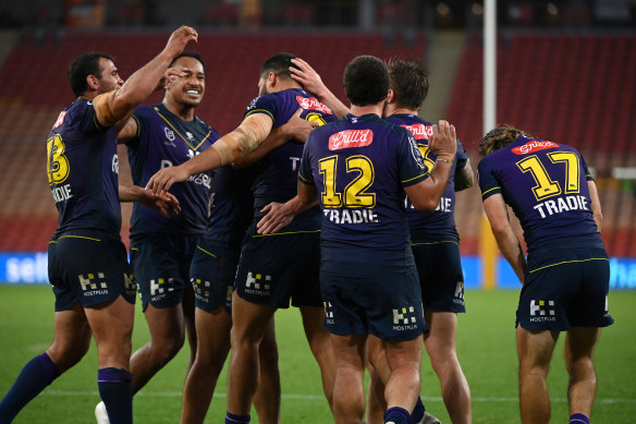Storm players celebrate a Jesse Bromwich try in the 27-point demolition of Penrith.