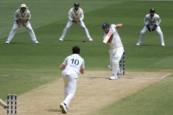 Mitchell Marsh drives the ball.