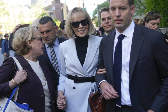 E. Jean Carroll (centre) leaves federal court in New York on Monday.