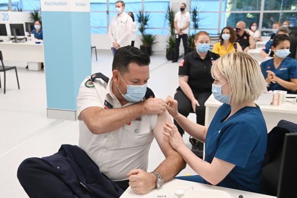 Ben Shepherd from the NSW Rural Fire Service receives his COVID-19 vaccine at the Olympic Park Vaccination Centre.
