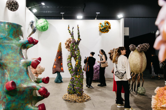 Visitors take in Christopher Langton’s Bad Biology at the Tolarno Galleries stand at the Melbourne Art Fair.