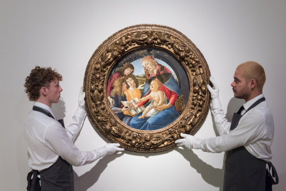 Art handlers hold a painting titled ‘Madonna of the Magnificat’ by Alessandro Filipepi, called Sandro Botticelli, from the estate of the philanthropist and co-founder of Microsoft, Paul G. Allen.