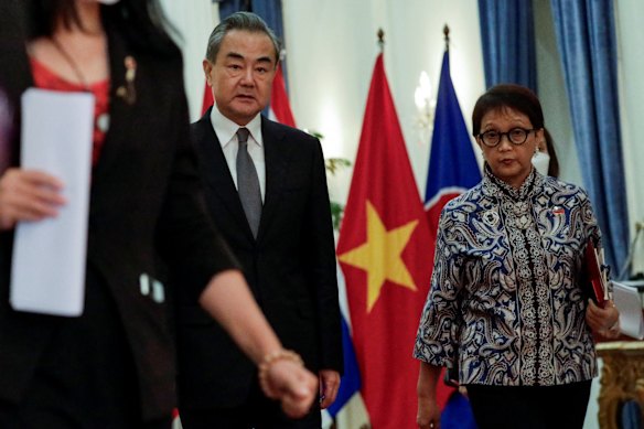Senior Chinese diplomat Wang Yi leaves a meeting with Indonesian Foreign Minister Retno Marsudi on the edges of the ASEAN retreat.