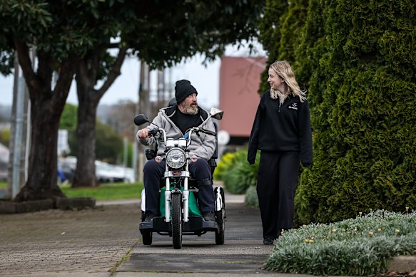 Barry, pictured with support co-ordinator McInnes, says he’d be lost without his motorised scooter.