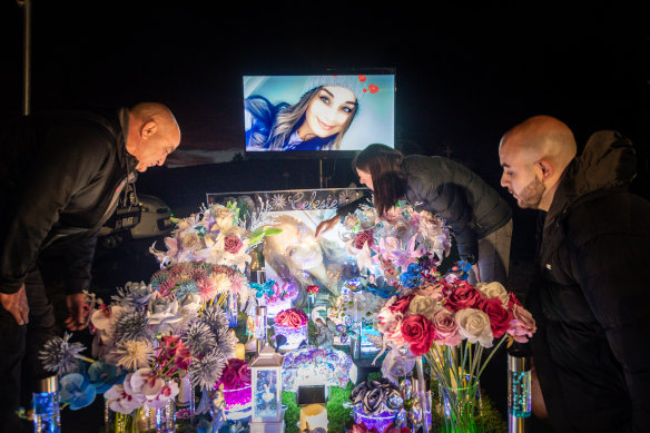 Family and friends gather at the grave of Celeste for a vigil in late February.