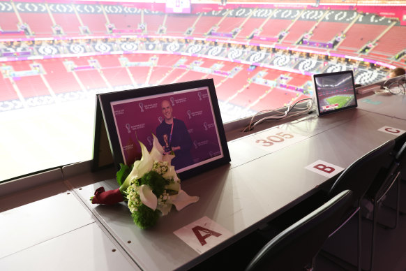 Flowers are placed in memory of Grant Wahl at the seat he had been assigned.