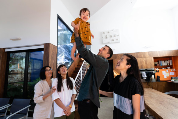 Architect Qianyi Lim (in black) with her partner, Ross Paxman, daughter, Linya, mother Kooiying Mah and sister, Xinyi Lim, in the home she designed at the back of a block in Chippendale.