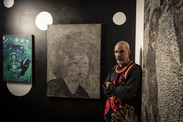 Boyd in his Marrickville studio. His painting of Angela Davis in the background speaks to the shared struggle of Black populations across the globe.