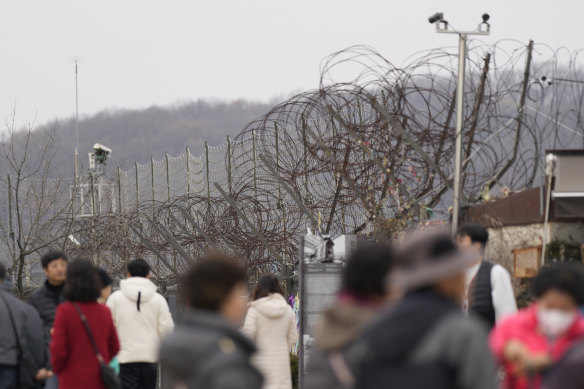 Visitors near the wire fence that devides the two countries, at the Imjingak Pavilion in Paju, South Korea.