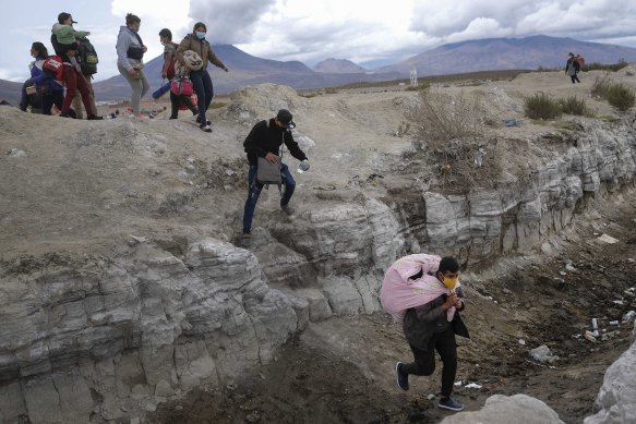 Migrants from Venezuela cross into Chile near Colchane from the Bolivian border last week. Hundreds of thousands of Venezuelans have fled the crisis at home to try a new life in Chile, Brazil and the US.