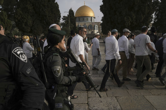 Israeli police escort Jewish visitors marking Passover to the al-Aqsa Mosque compound, known to Muslims as the Noble Sanctuary and to Jews as the Temple Mount, in the Old City of Jerusalem.