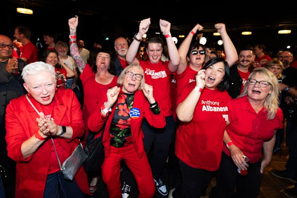 The winners: Labor supporters celebrate while watching the poll results appear on TV last Saturday night.