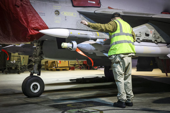 RAF Armourers prepare a Royal Air Force Typhoon FGR4 for air strikes against Houthi military targets in Yemen on Sunday.