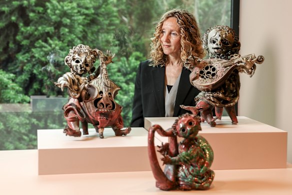 Curator Kendrah Morgan with works by John Perceval.