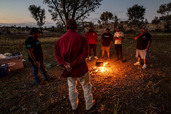 Red Dust Role Models on Country for a yarning circle catch up with Damien Kunoth (back to camera) and, from left, Tyrone Lynch, Chris Hagan, Dhandrey Hagan (Anmatyerr), Solomon George (Anmatyerr) and Alan Palmer.