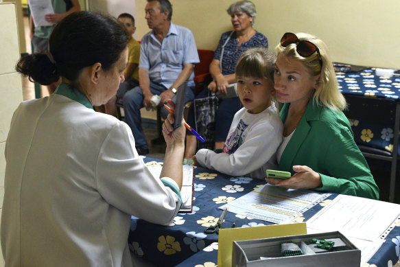 People receive iodine tablets at a distribution point in Zaporizhzhia, Ukraine.